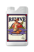 Revive 1 litre beyaz şişe – krem etiket, kırmızı mavi çerçeve, mor yaprak üzerinde figürlü çizim
